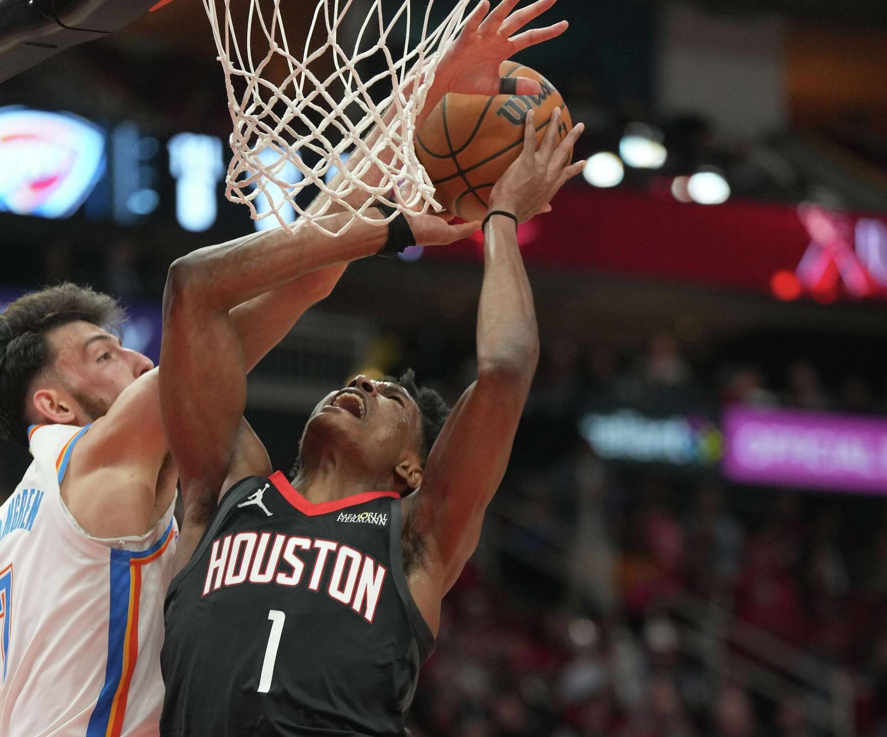 Houston Rockets guard Amen Thompson (1) is blocked from the basket by Oklahoma City Thunder center Chet Holmgren (7) at the Toyota Center in Houston on Thursday, Jan. 15, 2026.