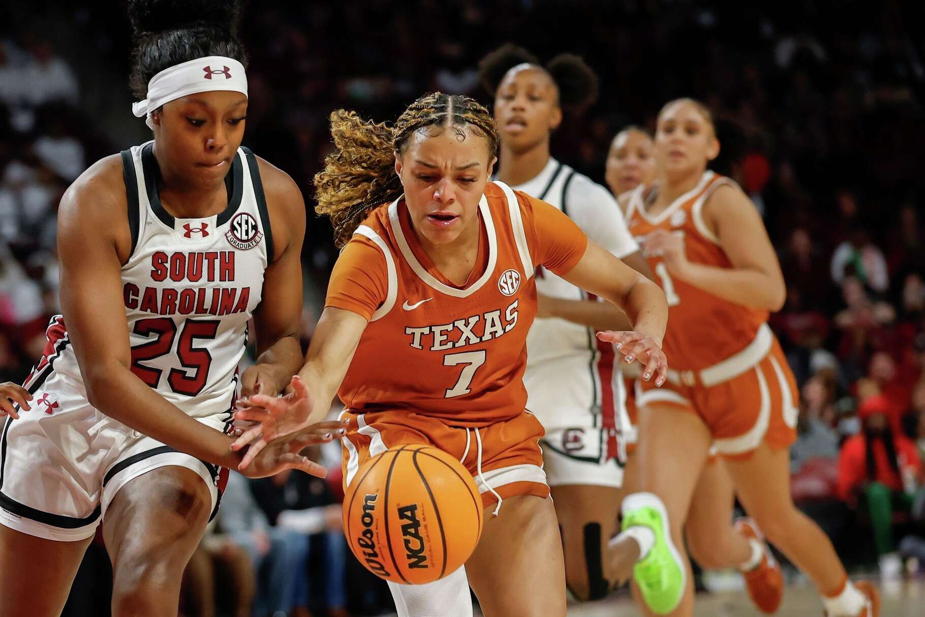 Texas guard Jordan Lee (7) battles South Carolina guard Raven Johnson for the ball during the first half of an NCAA college basketball game in Columbia, S.C., Thursday, Jan. 15, 2026. (AP Photo/Nell Redmond)