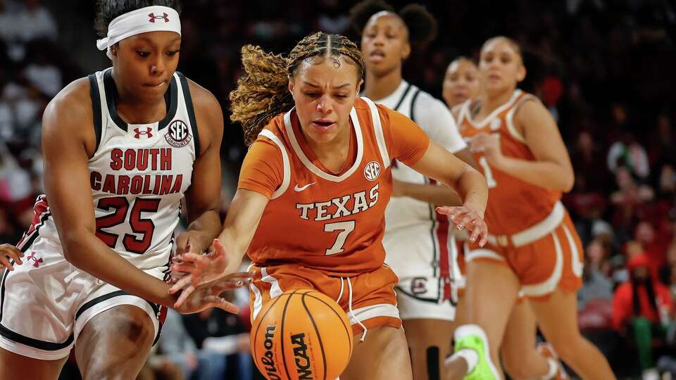 Texas guard Jordan Lee (7) battles South Carolina guard Raven Johnson for the ball during the first half of an NCAA college basketball game in Columbia, S.C., Thursday, Jan. 15, 2026. (AP Photo/Nell Redmond)