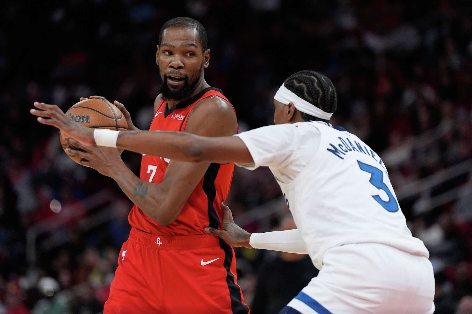 Minnesota Timberwolves forward Jaden McDaniels (3) defends against Houston Rockets forward Kevin Durant (7) during the first half of an NBA basketball game in Houston, Friday, Jan. 16, 2026. (AP Photo/Ashley Landis)