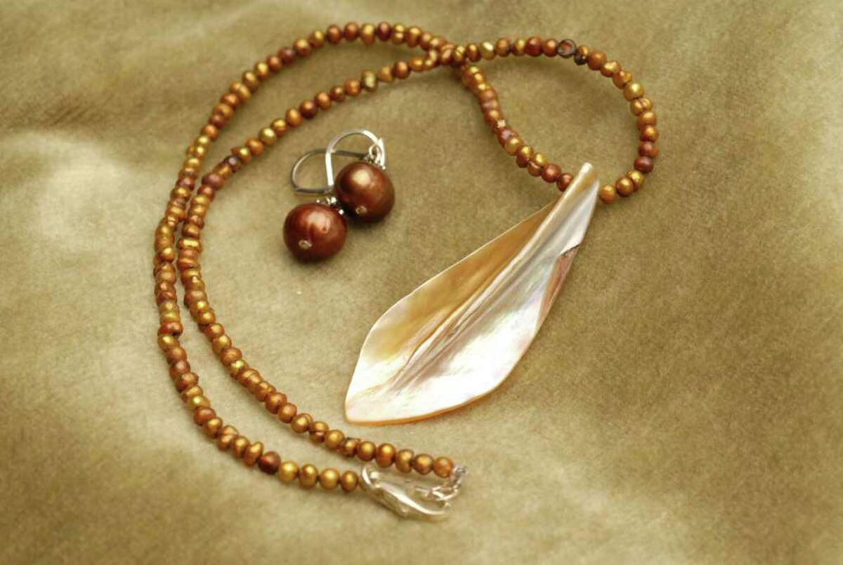 Elissa Halloran handmade jewelry. Copper freshwater pearl necklace with mother of pearl pendant, $45, and Copper freshwater pearl earrings, $29. Elissa Halloran Designs, 229 Lark St., Albany, 432-7090.
