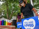 Social media specialist Sean PiƱa, left, and dating expert Brooklyn McKay joined other Match.com employees to install uplifting Kindfetti signs around the Oak Lawn neighborhood for World Kindness Day in 2020.