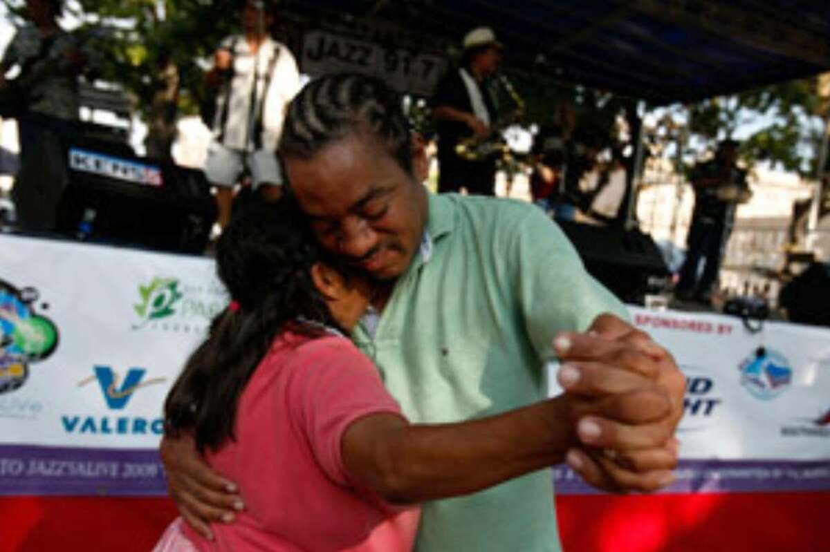 Dario Stanley and his partner dance to the music of Sax On Da Beach during Jazz'SAlive at Travis Park.