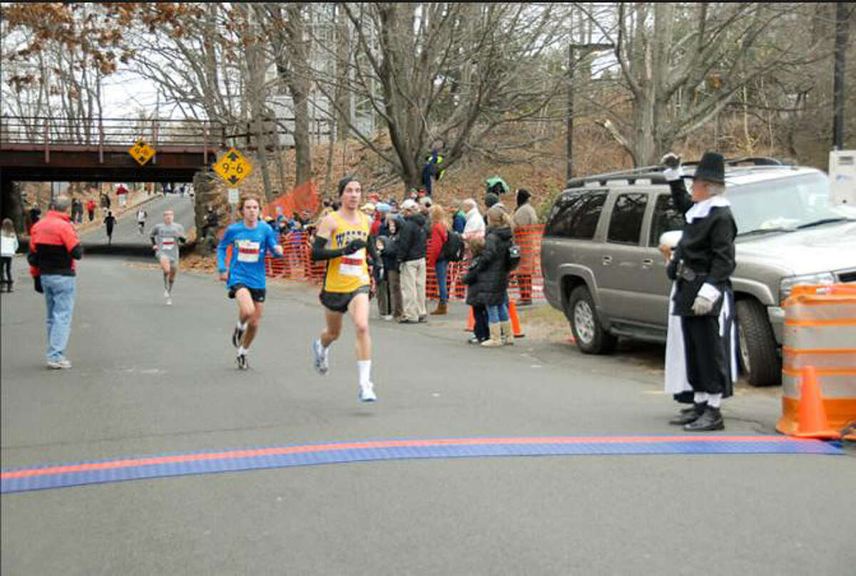 Steve Vento, front, and James Bloom of Weston finish eighth and 10th in the 33rd annual Pequot Runners Thanksgiving Road Race with times of 27:19 and 27:22, respectively, last Thursday.