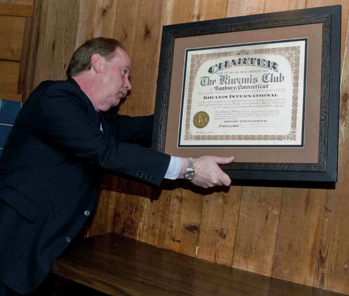 State Sen. Michael McLachlan hangs the original Kiwanis charter from Oct. 15, 1942 in the Tap Room of Chuck's Steak House. State Sen. McLachlan presented it to club members following their weekly Tuesday luncheon at Chuck's Steak House. Tuesday, Nov. 30, 2010