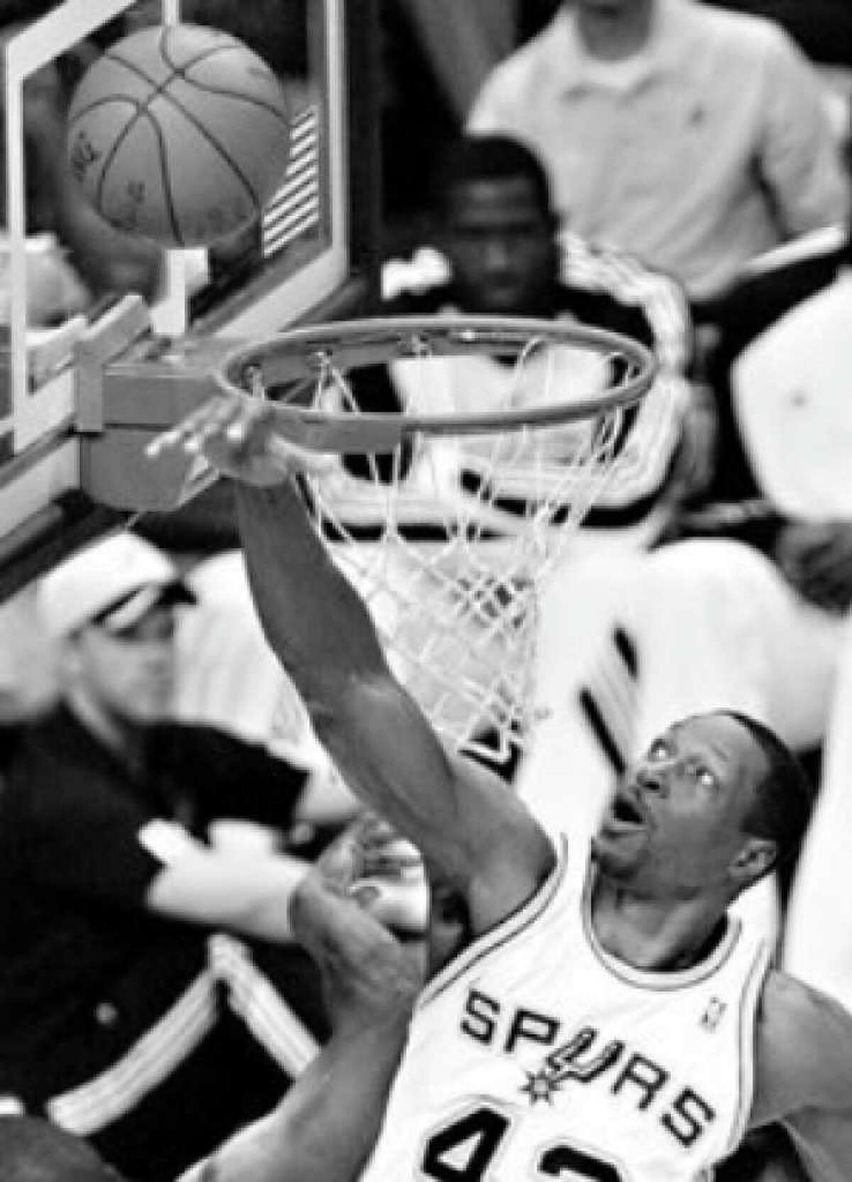 Center Theo Ratliff rejects a shot by Utah's Ronnie Brewer in the first half, one of his three blocked shots.