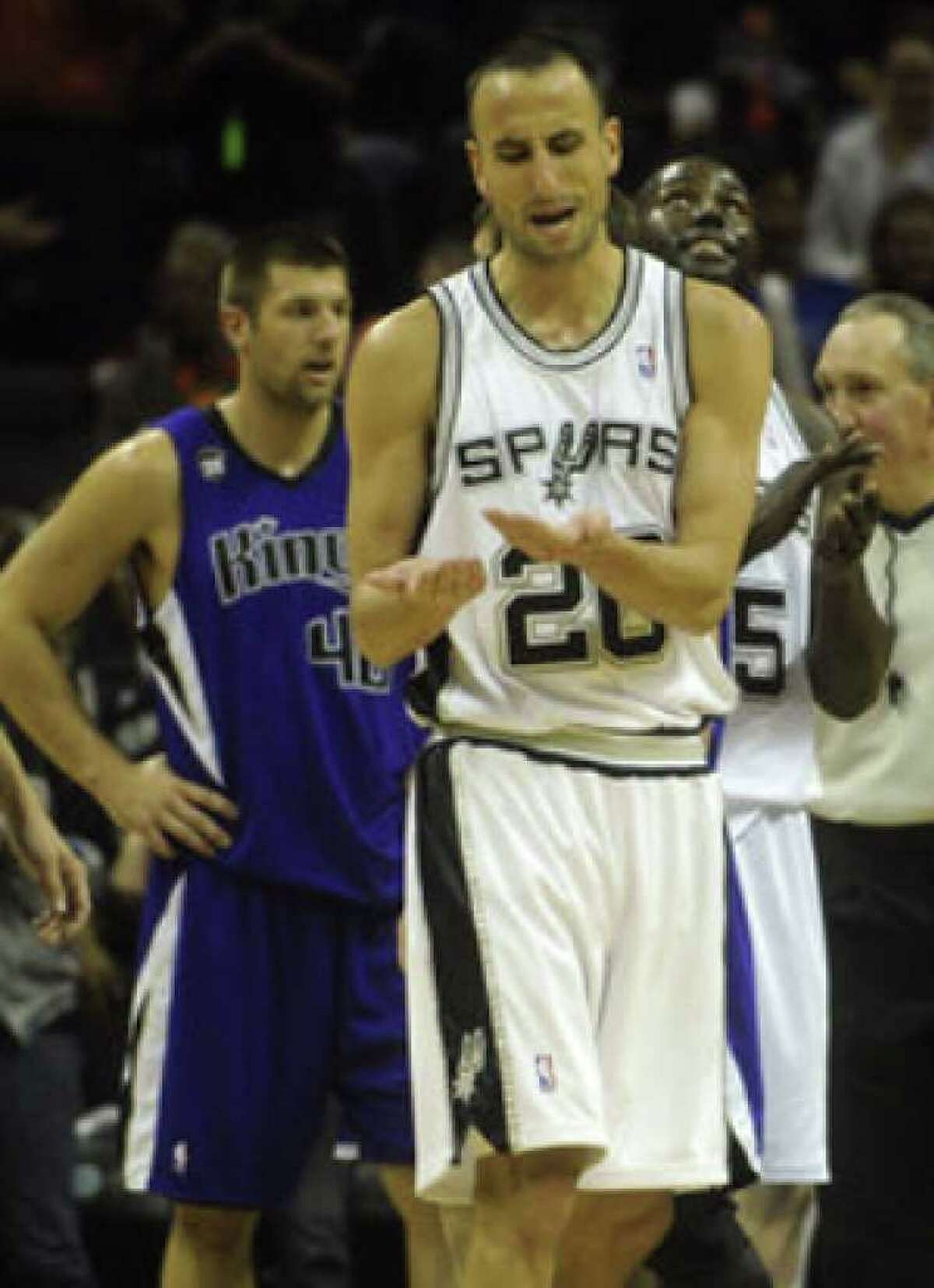 Manu Ginobili reacts after using hand sanitizer following the bat incident Saturday at the AT&T Center.