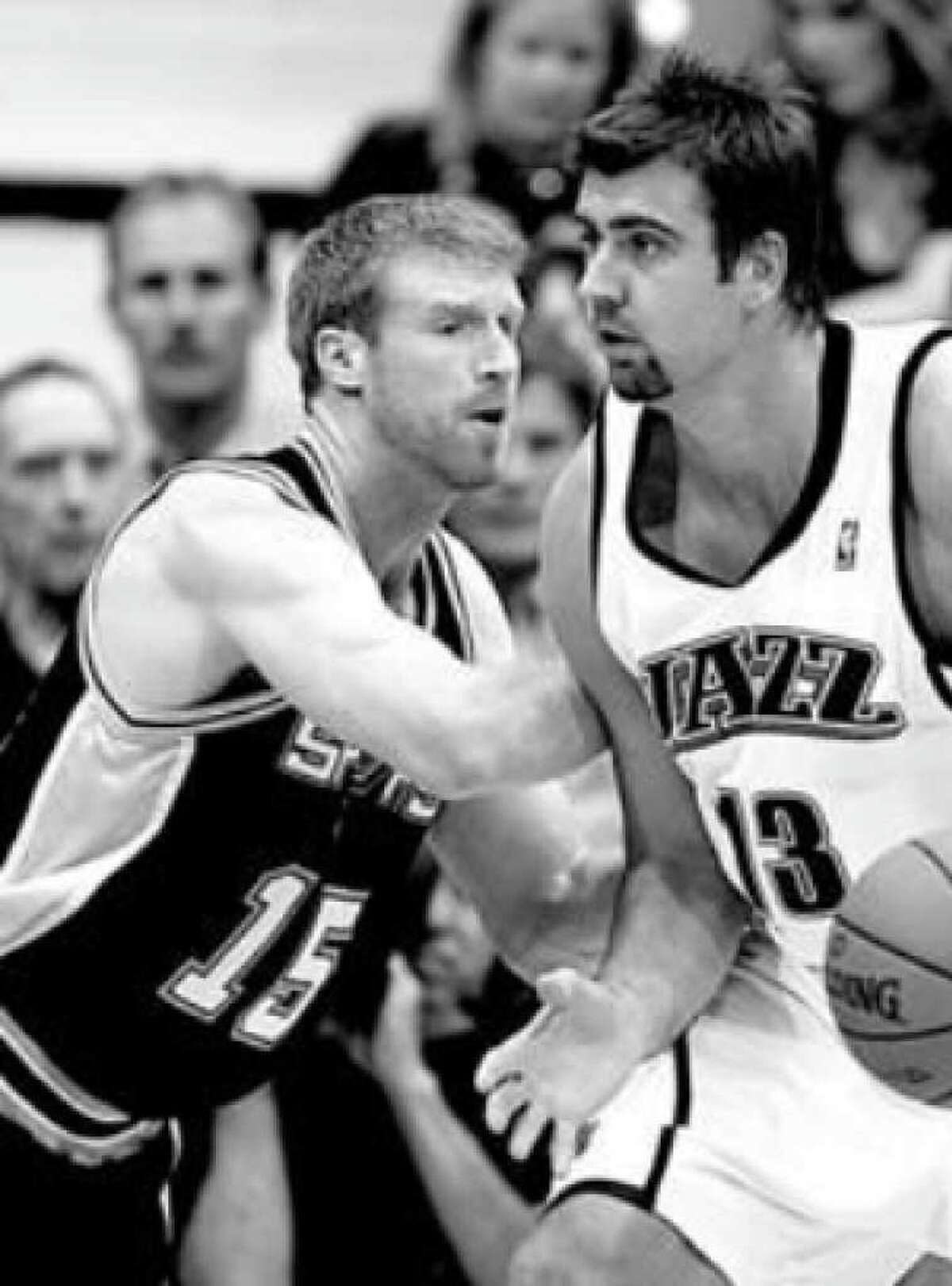 Spurs center Matt Bonner (left) guards Utah Jazz center Mehmet Okur down low during Thursday's late game.