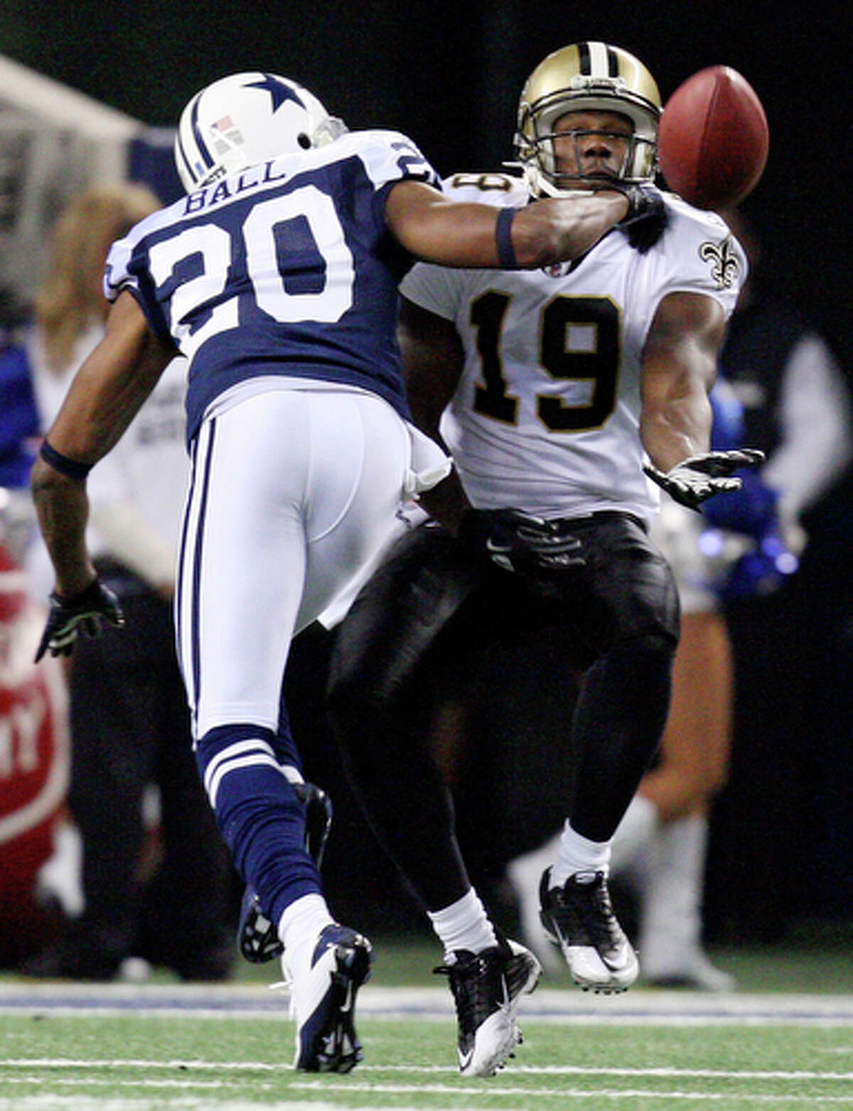 New Orleans Saints' Devery Henderson catches a pass as he is defended by Dallas Cowboys' Alan Ball.