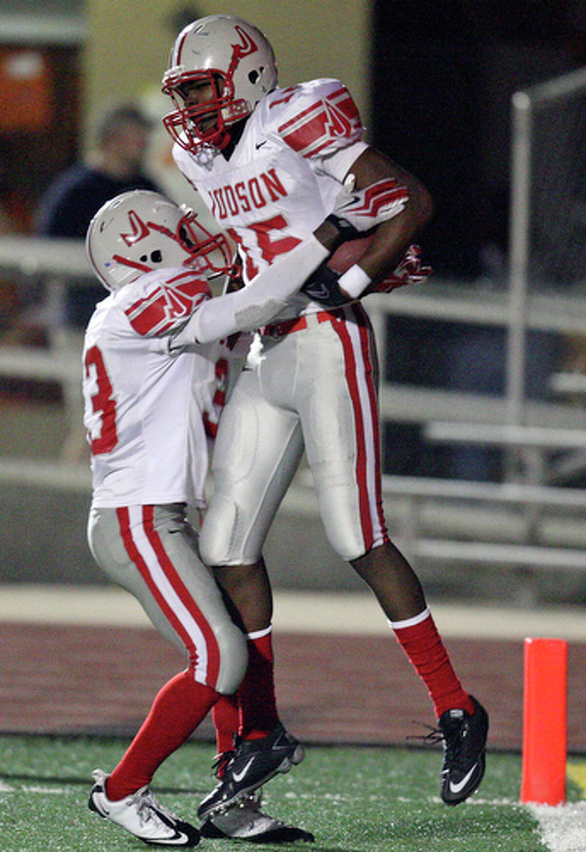 Judson's Isaac Gilmer (left) celebrates with teammate Judson's Tyrone Dotcie after Dotcie scored a touchdown against Madison Friday Nov. 12, 2010 at Comalander Stadium. Judson won 24-17.