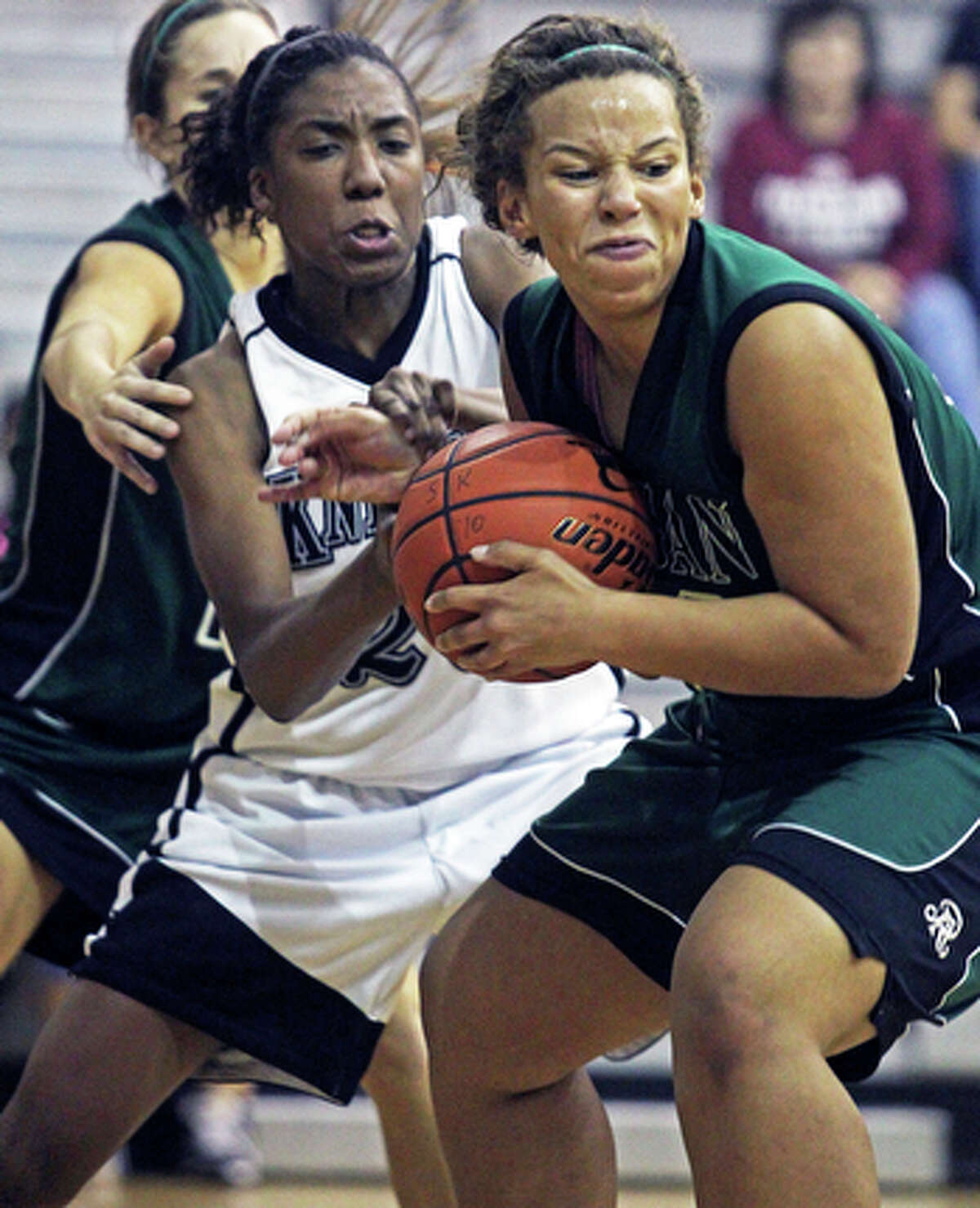 Reagan's Corrigan Tibbs muscles a defensive rebound away from the Knights' Taylor Calvert during game action in Steele's 74-54 win at Steele gym on Nov. 16, 2010.