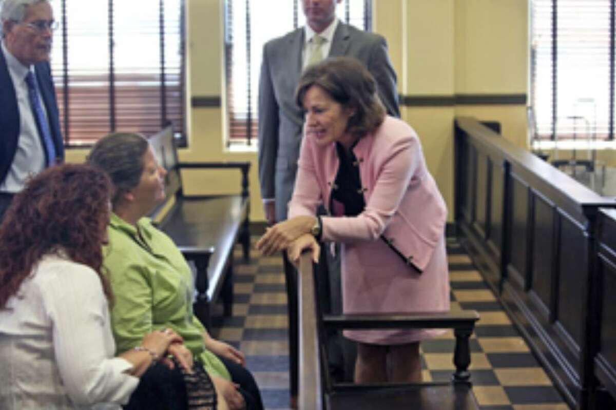 Judge Sharon Keller (right) talks to Marijo (left) and Paula Dixon, daughters of the victim in the Michael Richard case, during Keller's ethics hearing in 37th Distrcit Court on Thursday.