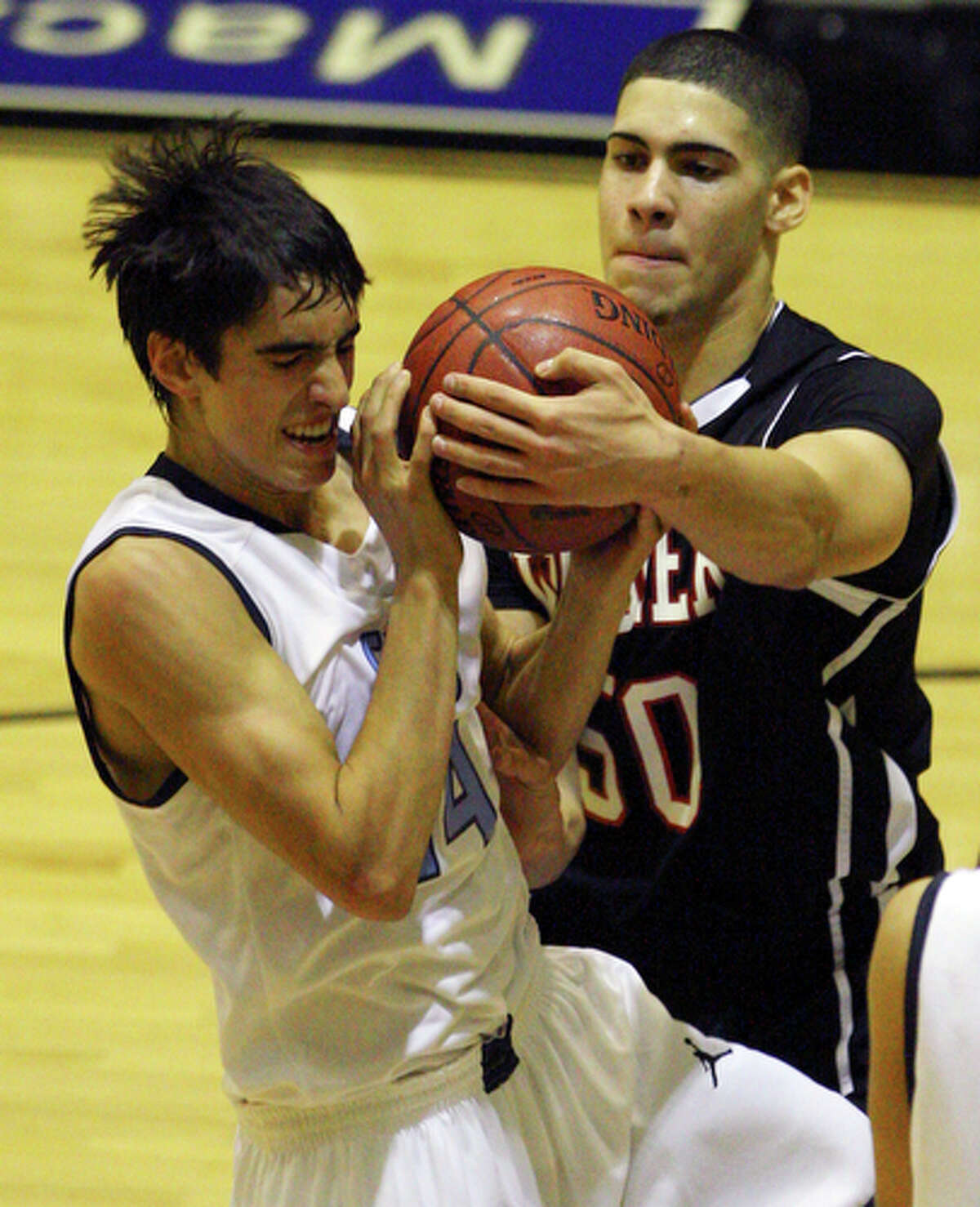 Johnson's Joey Louwagie and Wagner's Jose Negron struggle for control of the ball.