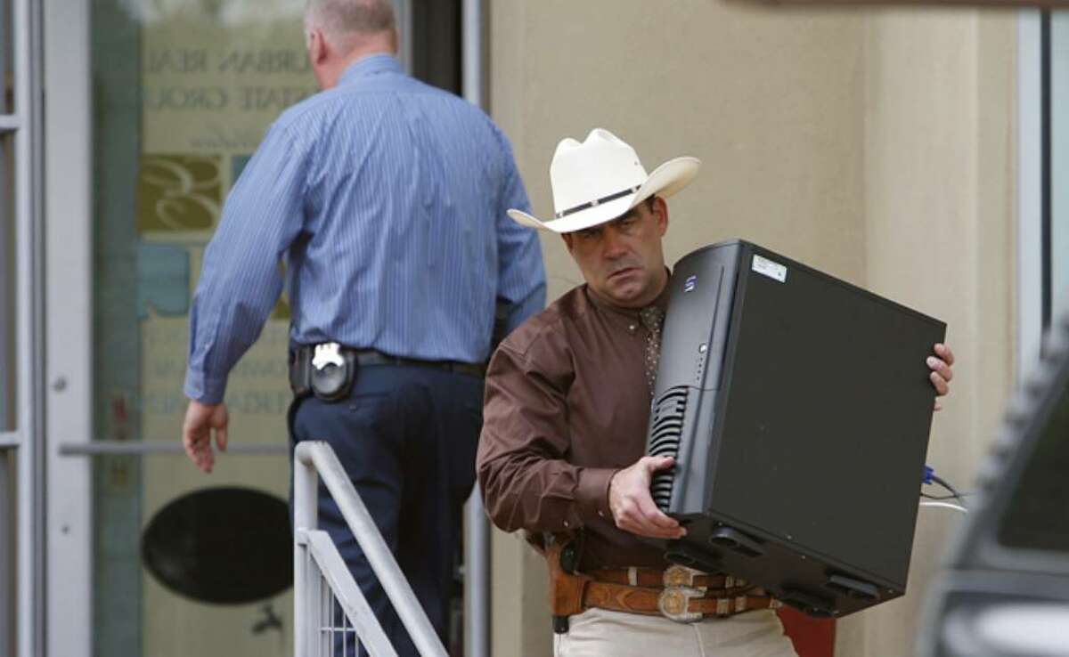 Texas Rangers along with the Bexar County District Attorney's Office remove items from a business affiliated with Gary Cain as part of an investigation.
