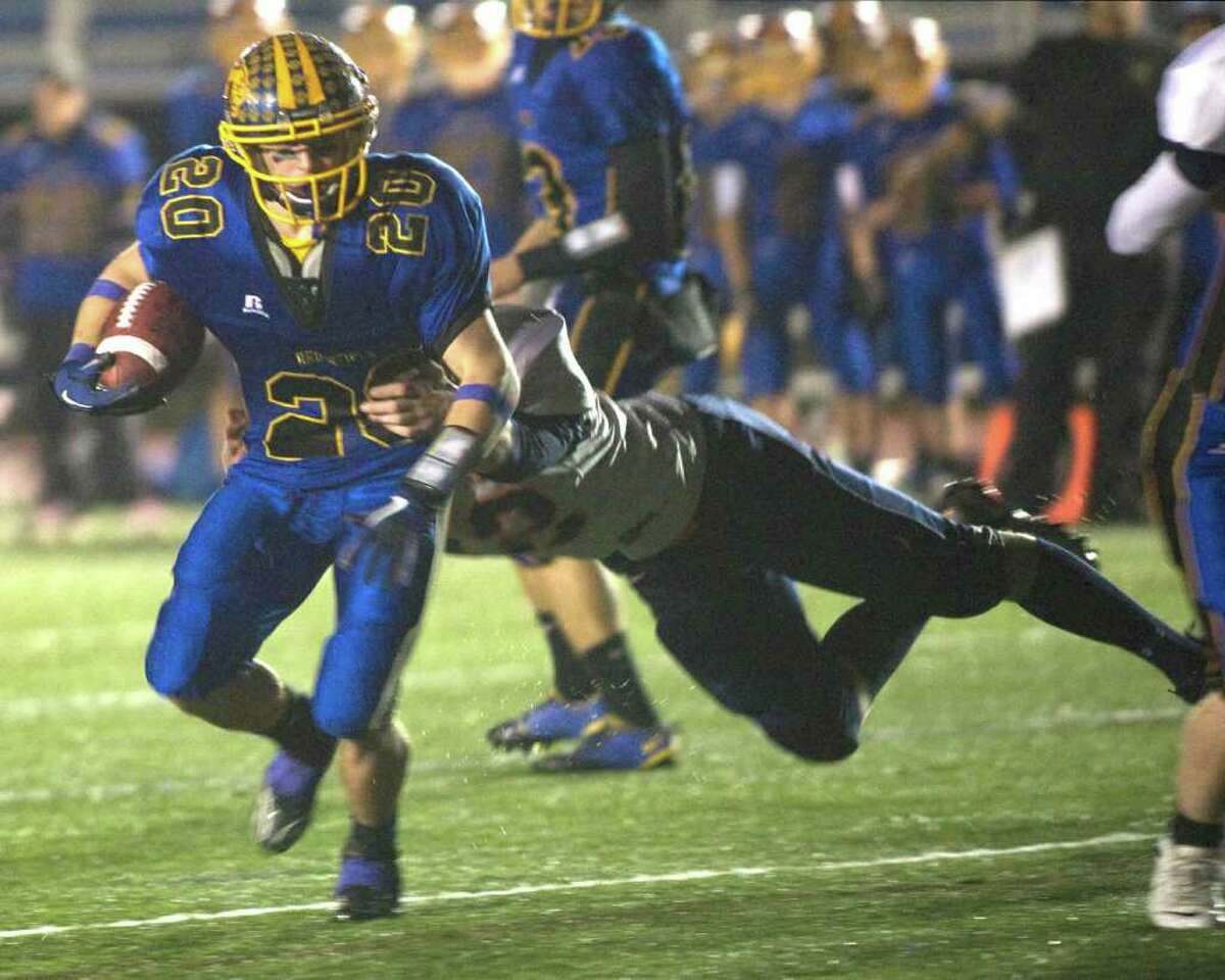 Brookfield's Brian Kelly breaks a Lyman Hall tackle on his way to a touchdown during the Class M state tournament quarterfinal game Tuesday night, Nov. 30, 2010, at Brookfield High School.