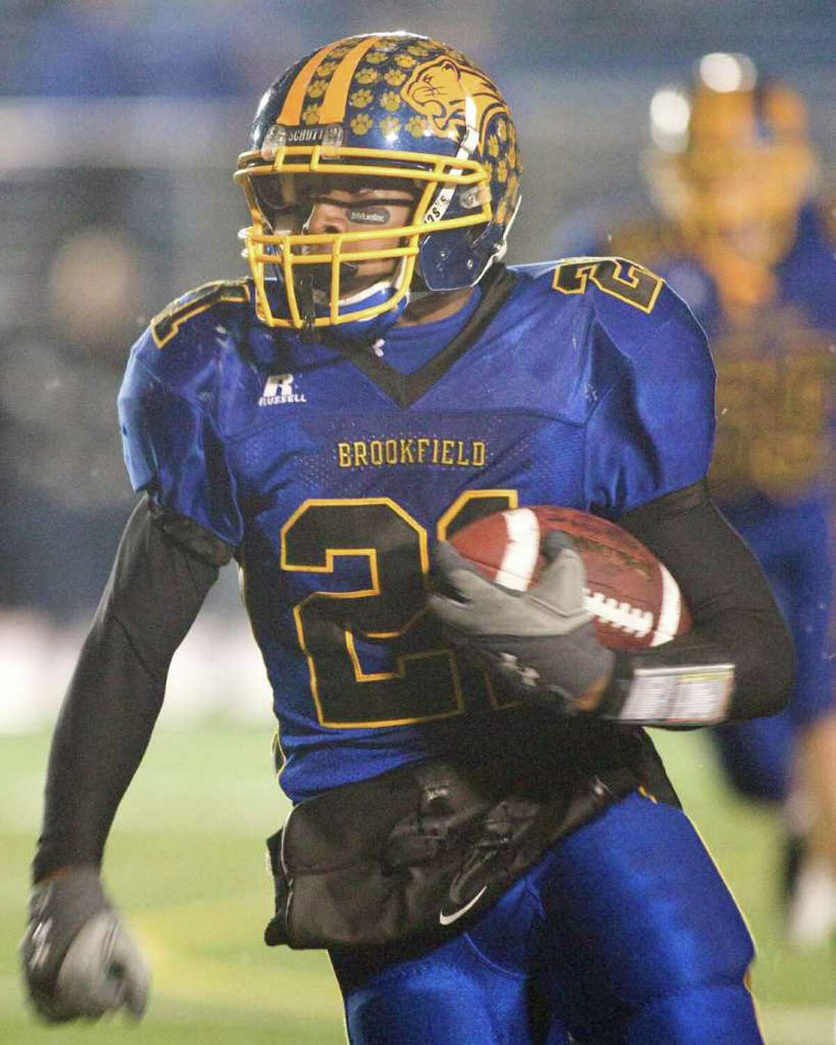 Brookfield's Leaon Gordon picks up a first down after catching a pass in the Bobcats' Class M state tournament quarterfinal game against Lyman Hall Tuesday night, Nov. 30, 2010, at Brookfield High School.