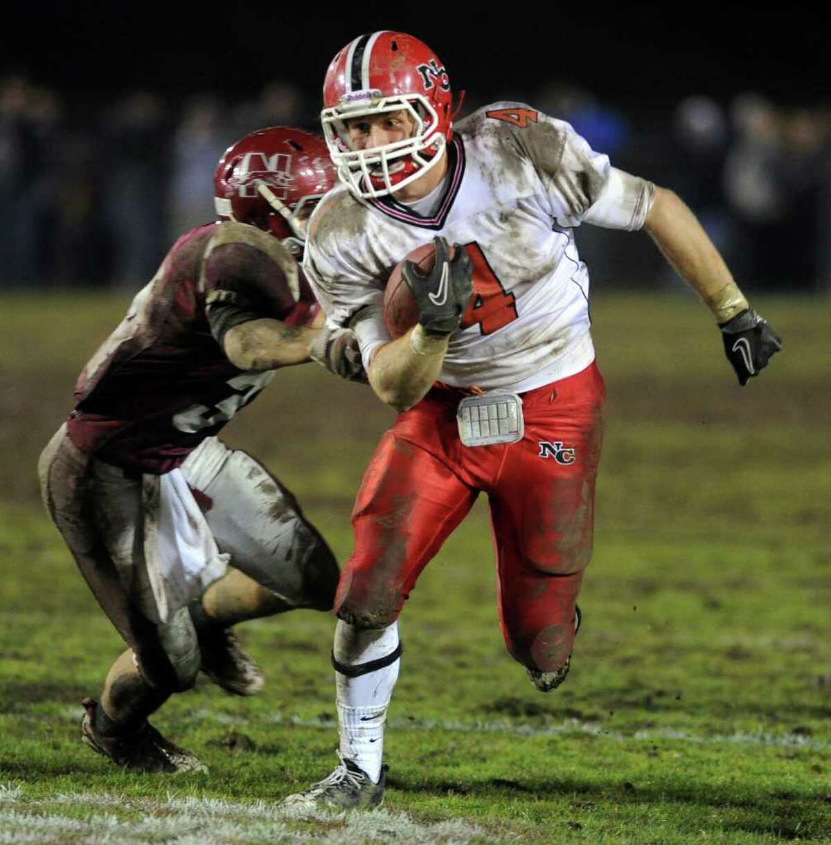 Kevein Macan of New Canaan carries the ball during Tuesday's Class L quarterfinal game at Naugatuck High School on November 30, 2010.