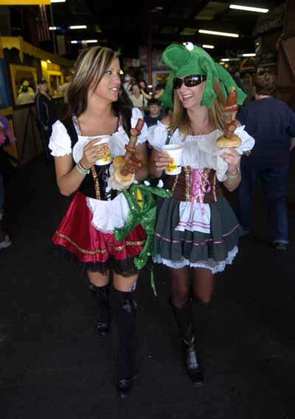 Shannon (left) and Amanda Smith stroll through Wurstfest with the traditional beer and sausages, Oct. 30, 2010.