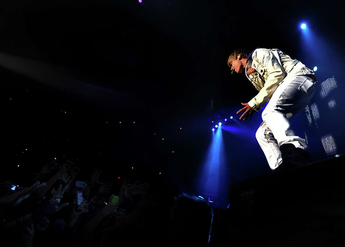 Fans reach out to Justin Bieber at the AT&T Center in San Antonio on Friday, Nov. 5, 2010. Burnham and Jasmine V. opened the show.