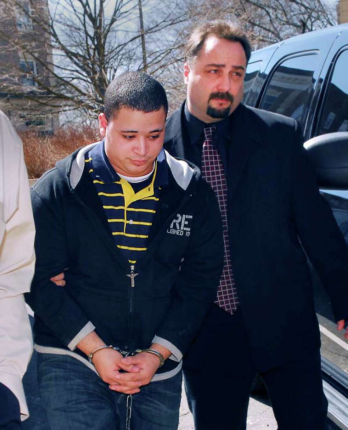 In this March 2008 file photo, Leonard Trujillo, of Worcester, Mass, left, is led into Greenwich police headquarters by Detective Pasquale Iorfino. Trujillo and Iorfino were both on the stand Thursday in state Superior Court in Stamford in the murder trial of Trujillo's cousin Carlos, who is accused in Kissel's death.
