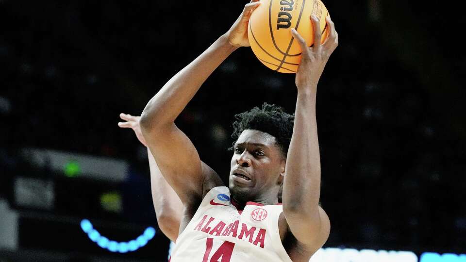 FILE - Alabama center Charles Bediako (14) pulls down a rebound while guarded by Maryland guard Ian Martinez, left, during the second half of a second-round college basketball game in the men's NCAA Tournament in Birmingham, Ala., March 18, 2023.