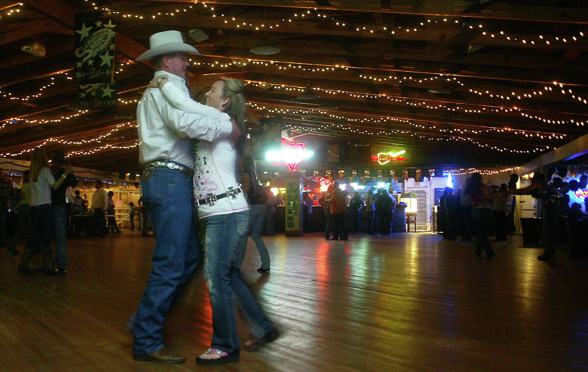 Victoria residents Brian Morris, 38, and his wife, Hollie, 37, two-step the night away at Schroeder Hall in Schroeder. SHAMINDER DULAI / HOUSTON CHRONICLE