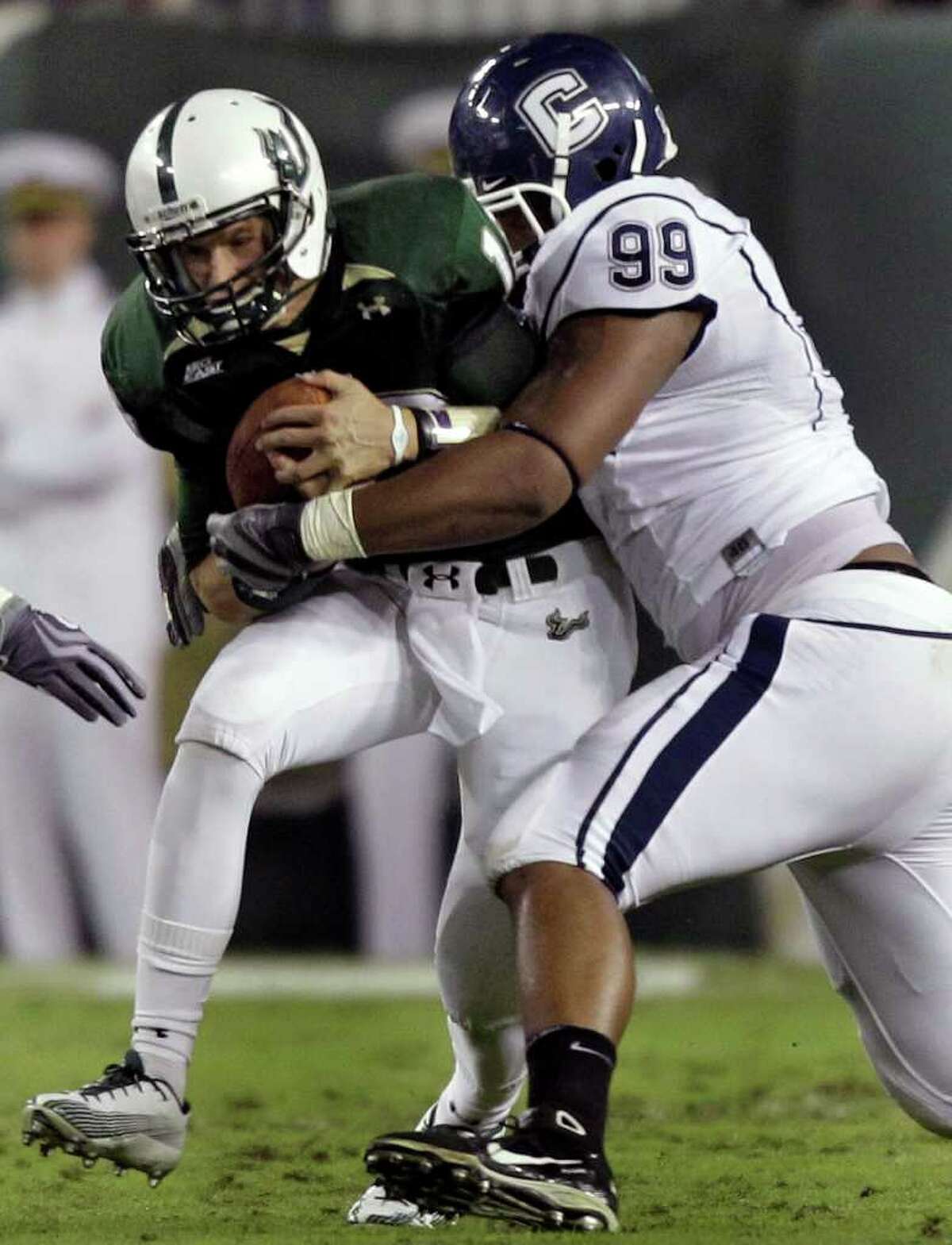 Connecticut defensive tackle Kendall Reyes (99) sacks South Florida quarterback Bobby Eveld during the first quarter of an NCAA college football game Saturday, Dec. 4, 2010, in Tampa, Fla. (AP Photo/Chris O'Meara)