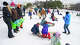 Parents and children prepare to sled down a hill at Murchison Middle School following a winter storm that brought rain, sleet and freezing temperatures to North Austin on Sunday, Jan. 25, 2026.