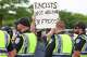 Frisco Police Department officials stop counter protestors from passing the fence line during a protest held by the group Protect White Americans, on Saturday, April 19, 2025, at David Kuykendall Stadium in Frisco.