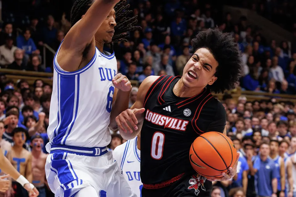Louisville's Mikel Brown Jr. (0) drives as Duke's Maliq Brown (6) defends during the first half of an NCAA college basketball game in Durham, N.C., Monday, Jan. 26, 2026.