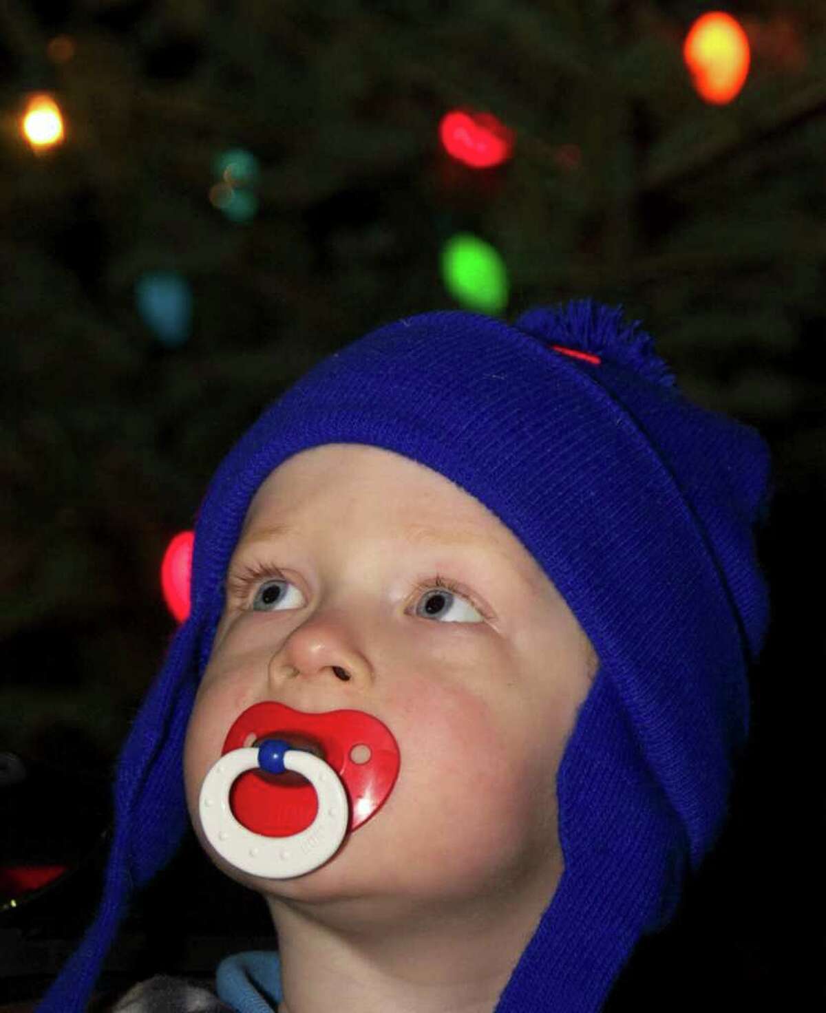 SPECTRUM/Thomas Mason, 2 of New Milford soaks in the sound of "Jingle Bells" as he admires the bright lights of the Christmas trees on the Village Green during the Village Center Organization's Dec. 3, 2010 Festival of Lights and other downtown holiday events.