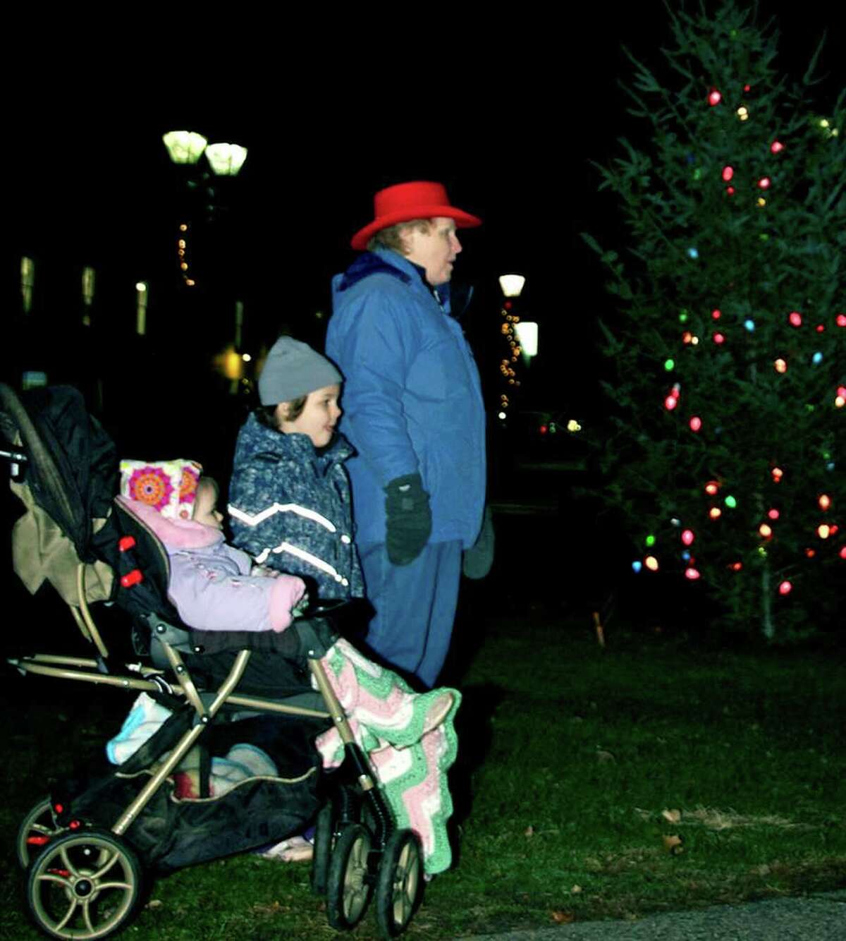 SPECTRUM/That's Bonnie Knapp of New Milford with grandchildren Harper Knapp, 4, and Marley Knapp, almost 2, singing carols on the Village Green during the Village Center Organization's Dec. 3, 2010 Festival of Lights and other downtown holiday events.