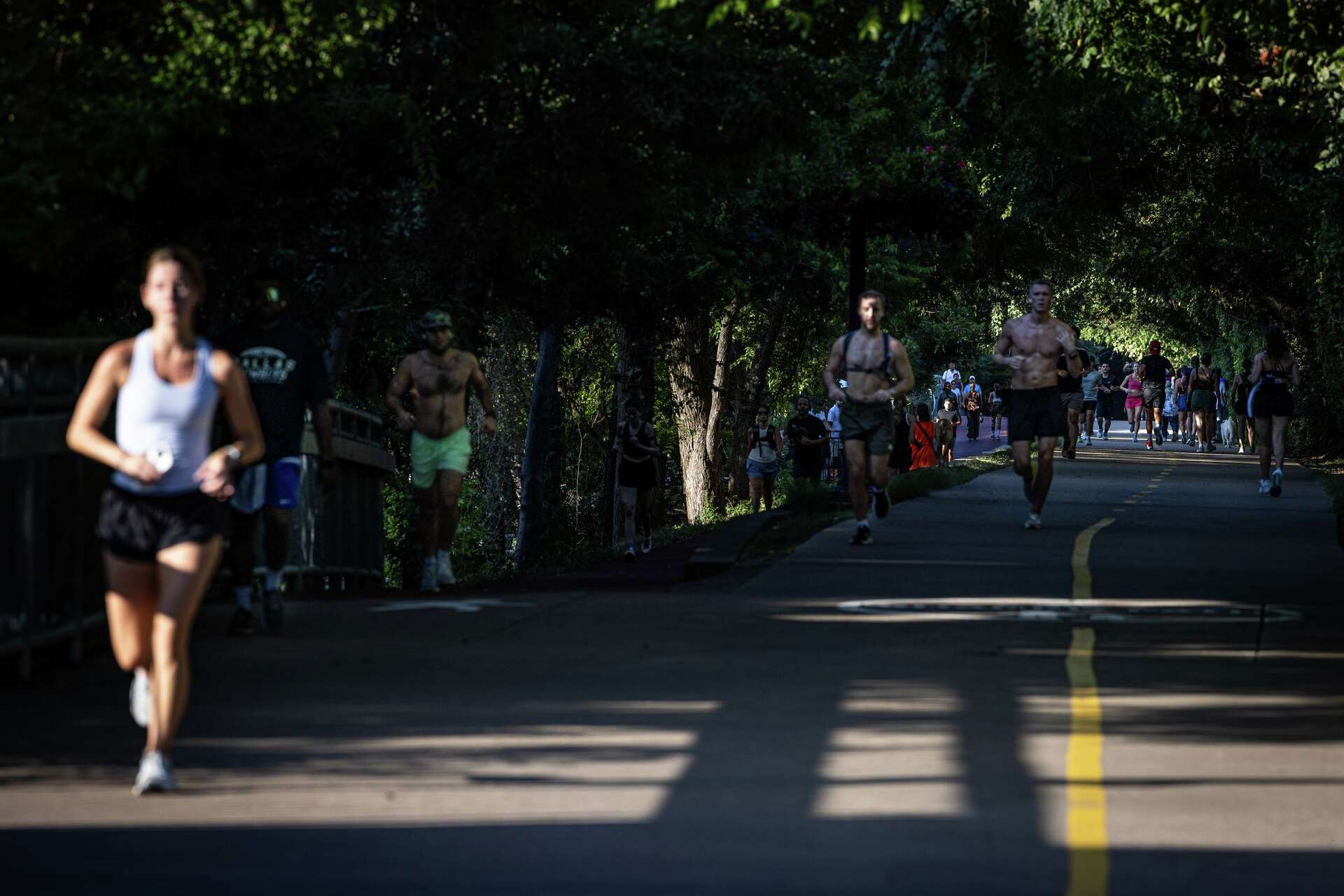 Pedestrians jog and walk along Katy Trail near Uptown on Saturday morning Aug. 16, 2025, in Dallas.