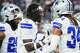 Dallas Cowboys linebacker Demarvion Overshown (0) shakes hands with cornerback Shavon Revel Jr. as the team warms up before an NFL football game against the Philadelphia Eagles at AT&T Stadium on Sunday, Nov. 23, 2025, in Arlington.