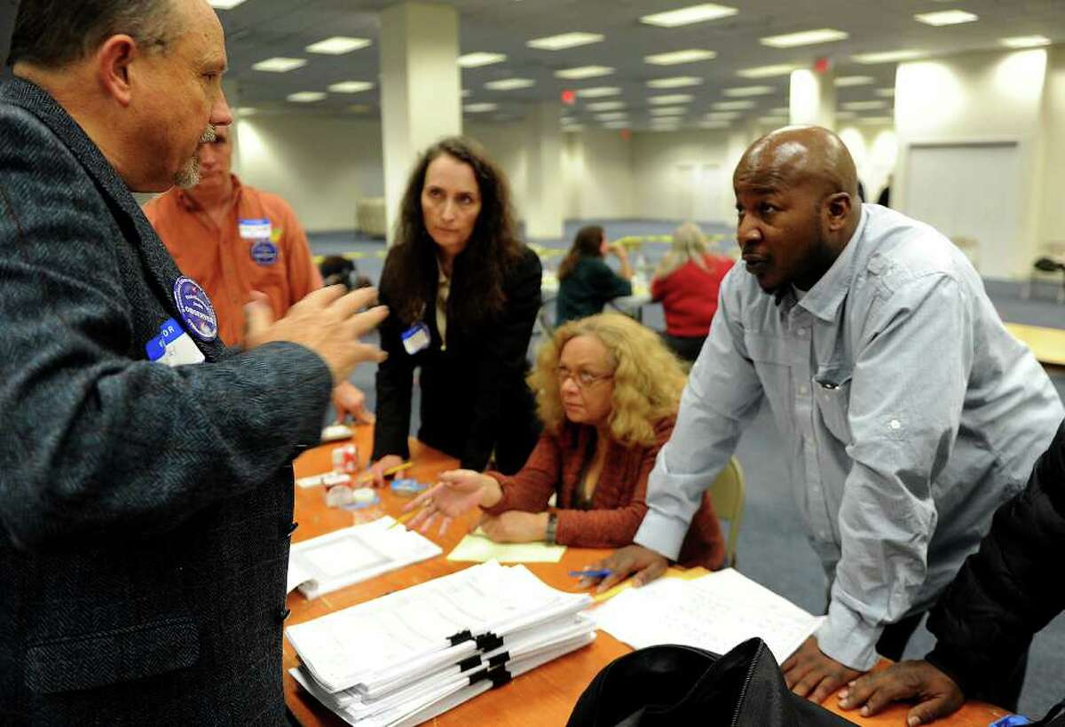 From left, Luther Weeks, Cheryl Denson, Sandi Ayala and James Mullen look at recount results at City Hall Annex on Friday, December 3, 2010.