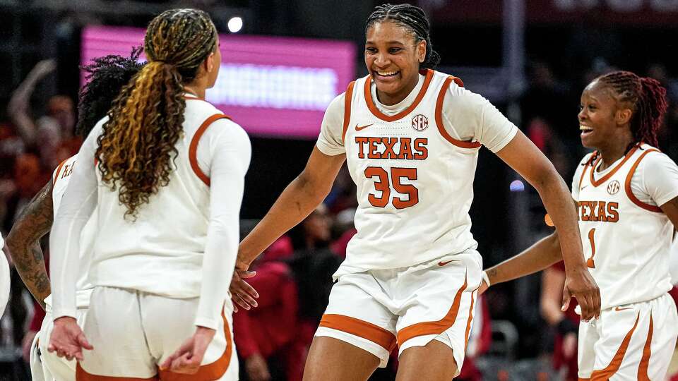 Texas Longhorns guard Madison Booker (35) and guard Jordan Lee (7) celebrate during an Oklahoma timeout in the game at the Moody Center on Sunday, Feb. 1, 2026 in Austin.