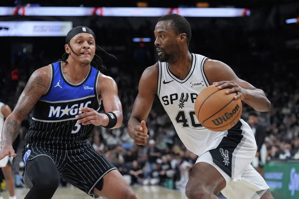 San Antonio Spurs forward Harrison Barnes (40) drives against Orlando Magic forward Paolo Banchero (5) during the second half of an NBA basketball game in San Antonio, Sunday, Feb. 1, 2026. (AP Photo/Eric Gay)