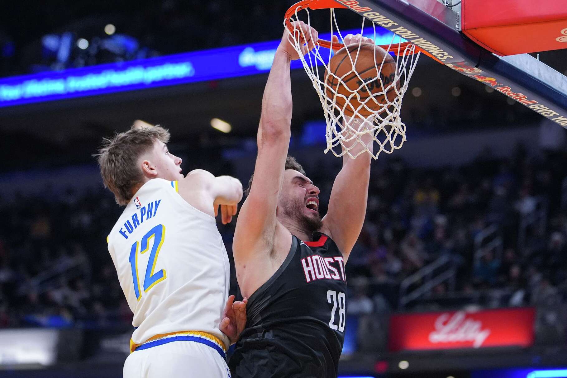 Houston Rockets center Alperen Sengun (28) gets a dunk in front of Indiana Pacers guard Johnny Furphy (12) during the second half of an NBA basketball game in Indianapolis, Monday, Feb. 2, 2026. (AP Photo/Michael Conroy)