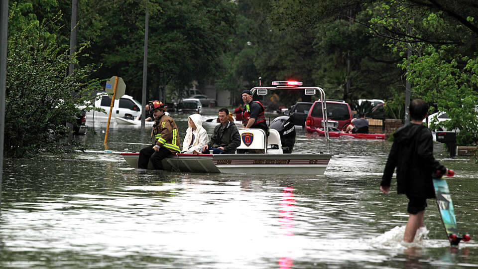 A water rescue boat from the Crosby Volunteer Fire Department delivers people to high ground in the Bear Creek Village subdivision after flooding from heavy rain Monday, April 18, 2016, in Houston.