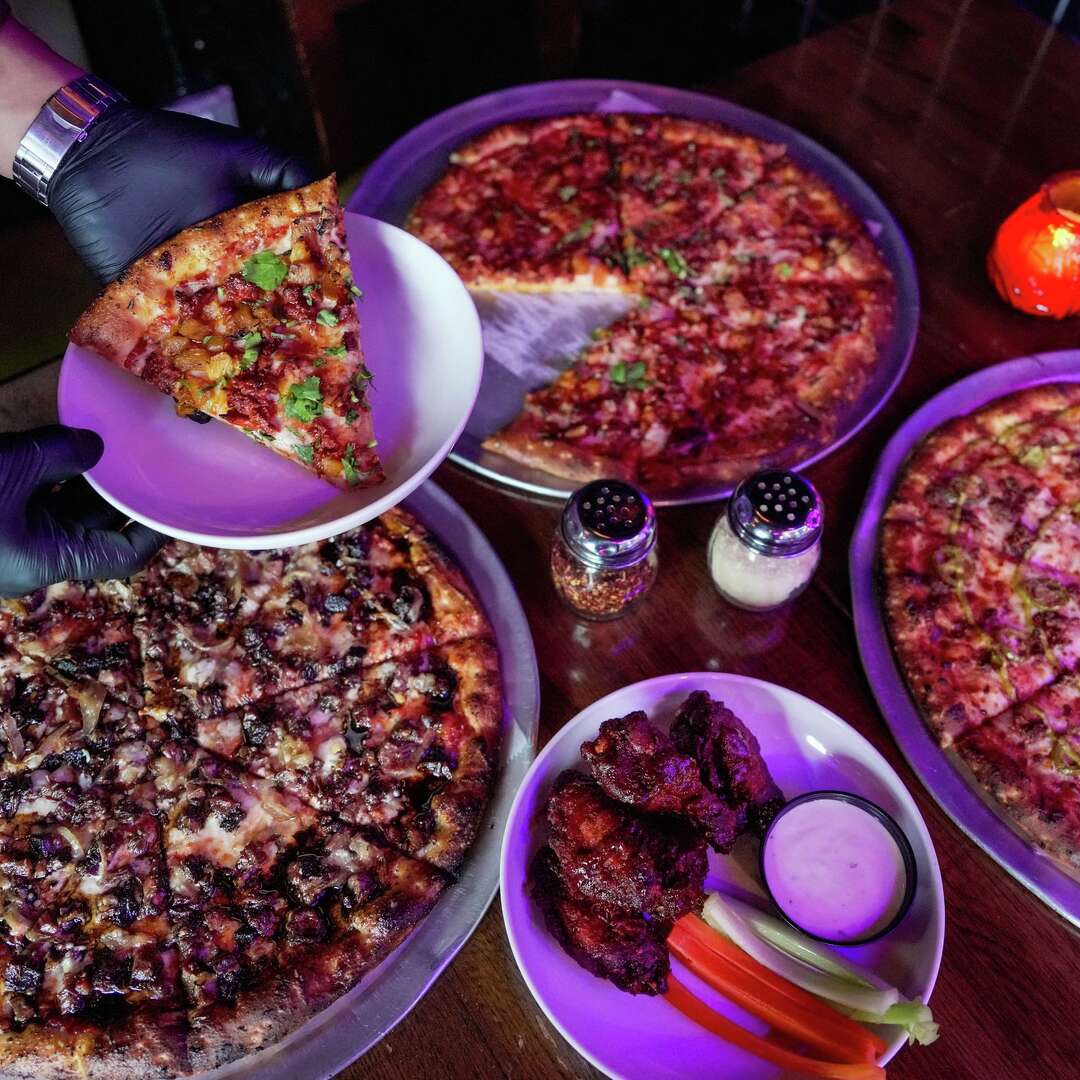 Pizzas and wings are photographed at Pinball Pizzeria in Houston, Tuesday, Feb. 3, 2026.