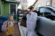 Shannon Oster-Gabrielson opens her vehicle door to drive her daughters to school as her daughter Eve Gabrielson, 7, looks on outside of their home in San Antonio on Wednesday, Feb. 4, 2026. Eve, and her sister Ellie Gabrielson, 9, had previously attended Lamar Elementary School — down the block from their home. The school closed down and Oster-Gabrielson now drives her children to Hawthorne Academy.