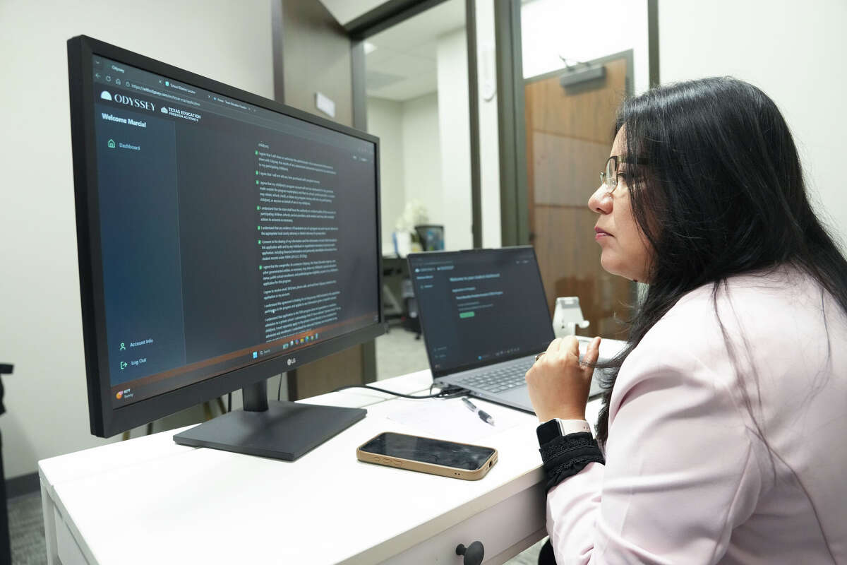 Marcia Pena works to apply for a Texas Education Freedom Account voucher for her daughter's catholic school next year in Houston, Wednesday, Feb. 4, 2026. Wednesday was the first day that the applications opened for parents to take part in Texas' new program to utilize tax dollars as part of school choice.