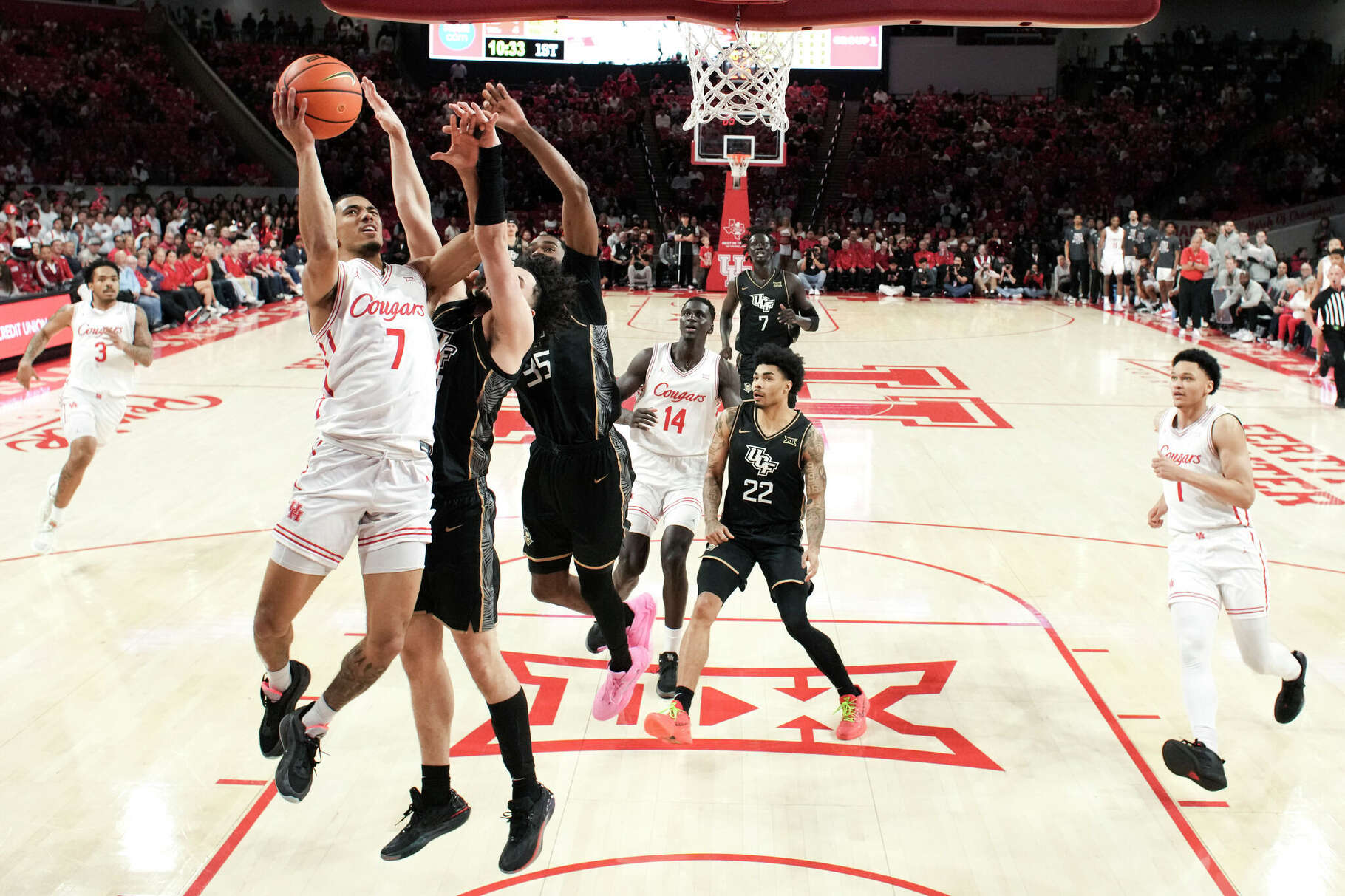 Houston guard Milos Uzan (7) draws contact as he shoots during the first half of an NCAA college basketball game in Houston, Wednesday, Feb. 4, 2026.