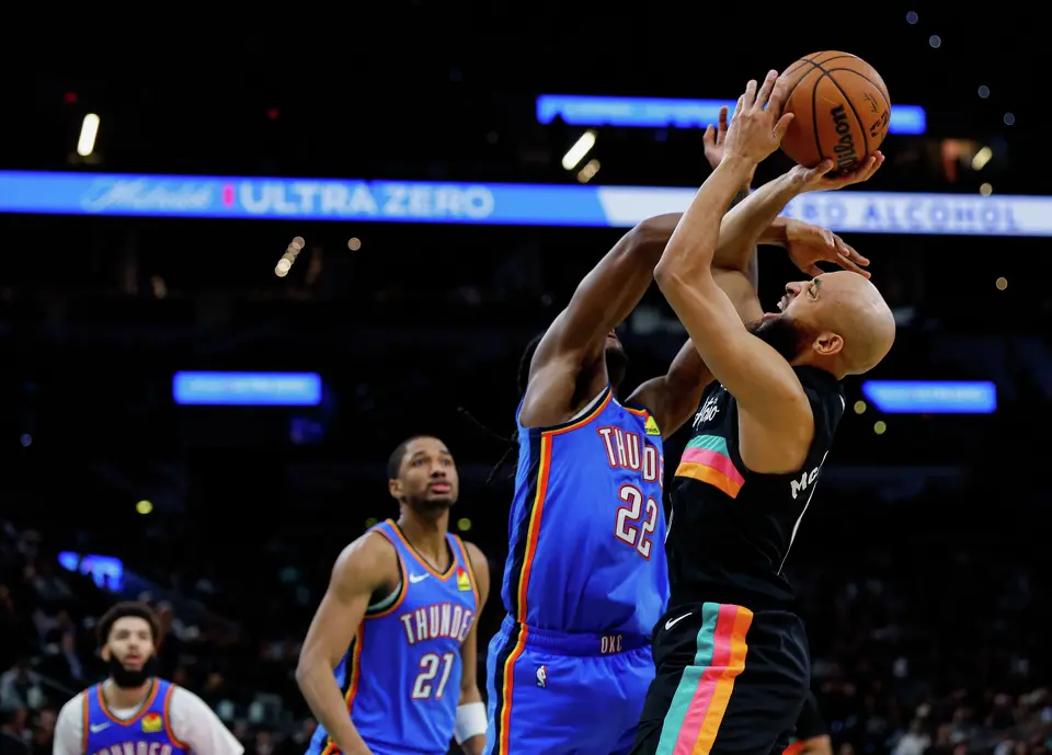 San Antonio Spurs guard Jordan McLaughlin (0) is fouled by Oklahoma City Thunder guard Cason Wallace (22) during the fourth quarter at Frost Bank Center in San Antonio, Wednesday, Feb. 4, 2026. The Spurs defeated the Thunder, 116-106.
