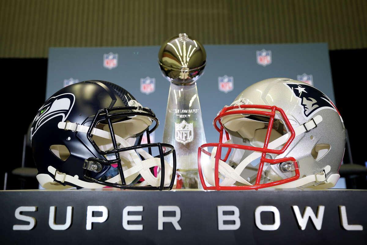 The Vince Lombardi Trophy is framed by the Seattle Seahawks and New England Patriots helmets during Super Bowl LX Opening Night at San Jose McEnery Convention Center on February 02, 2026 in San Jose, California. 