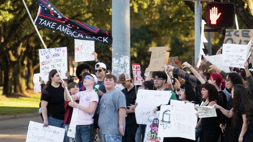 Students in support of U.S. President Donald Trump stand in front of supporters against ICE after a walkout to protest against ICE, despite threats from Gov. Greg Abbott and the Texas Education Agency, Friday, Feb. 6, 2026, in Kingwood. Abbott warned students, teachers and school could face serious consequences for acts of activism during the school day.