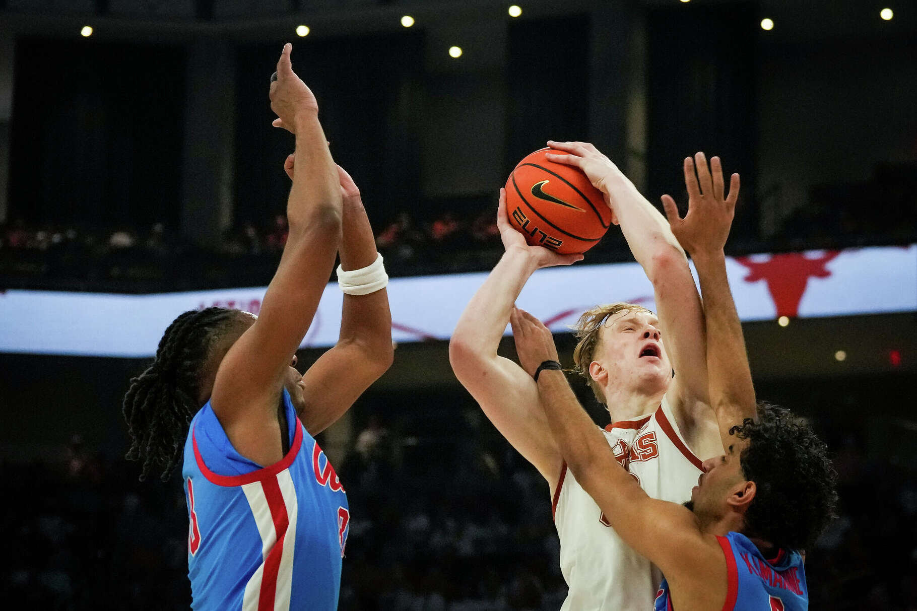 Texas Longhorns center Matas Vokietaitis (8) battles defend from Mississippi Rebels guard Ilias Kamardine (6) to get the ball up in the second half of the Longhorns' game against the Ole Miss Rebels at the Moody Center in Austin, Saturday, Feb. 7, 2026. Texas won the game 79-68.