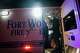A Fort Worth Fire Department paramedic holds a unit of blood as a team works to transfuse a gunshot victim in the back of an ambulance.