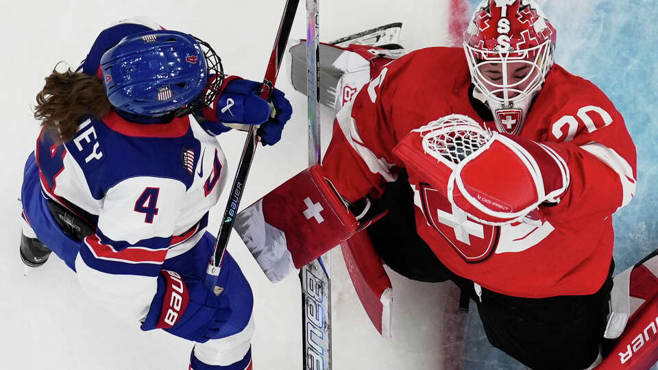 Switzerland's Andrea Brandli makes a save against United States' Caroline Harvey during a preliminary round match of women's ice hockey between the United States and Switzerland at the 2026 Winter Olympics, in Milan, Italy, Monday, Feb. 9, 2026.