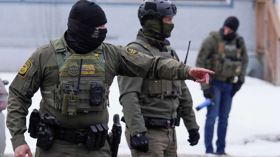 A United States Border Patrol agent gestures to a car while conducting immigration enforcement operations, Thursday, Feb. 5, 2026, in Minneapolis.